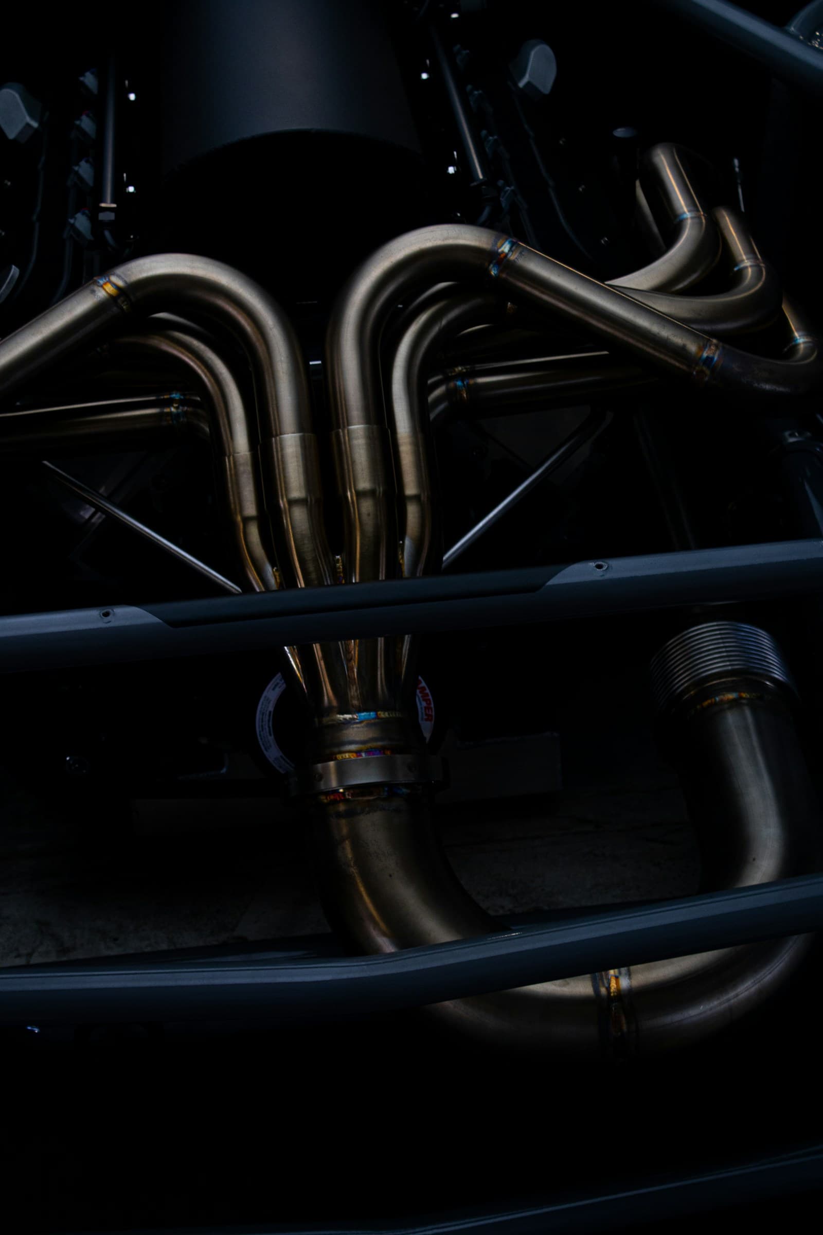 Close-up of a car exhaust system showing pipes and silencer sections